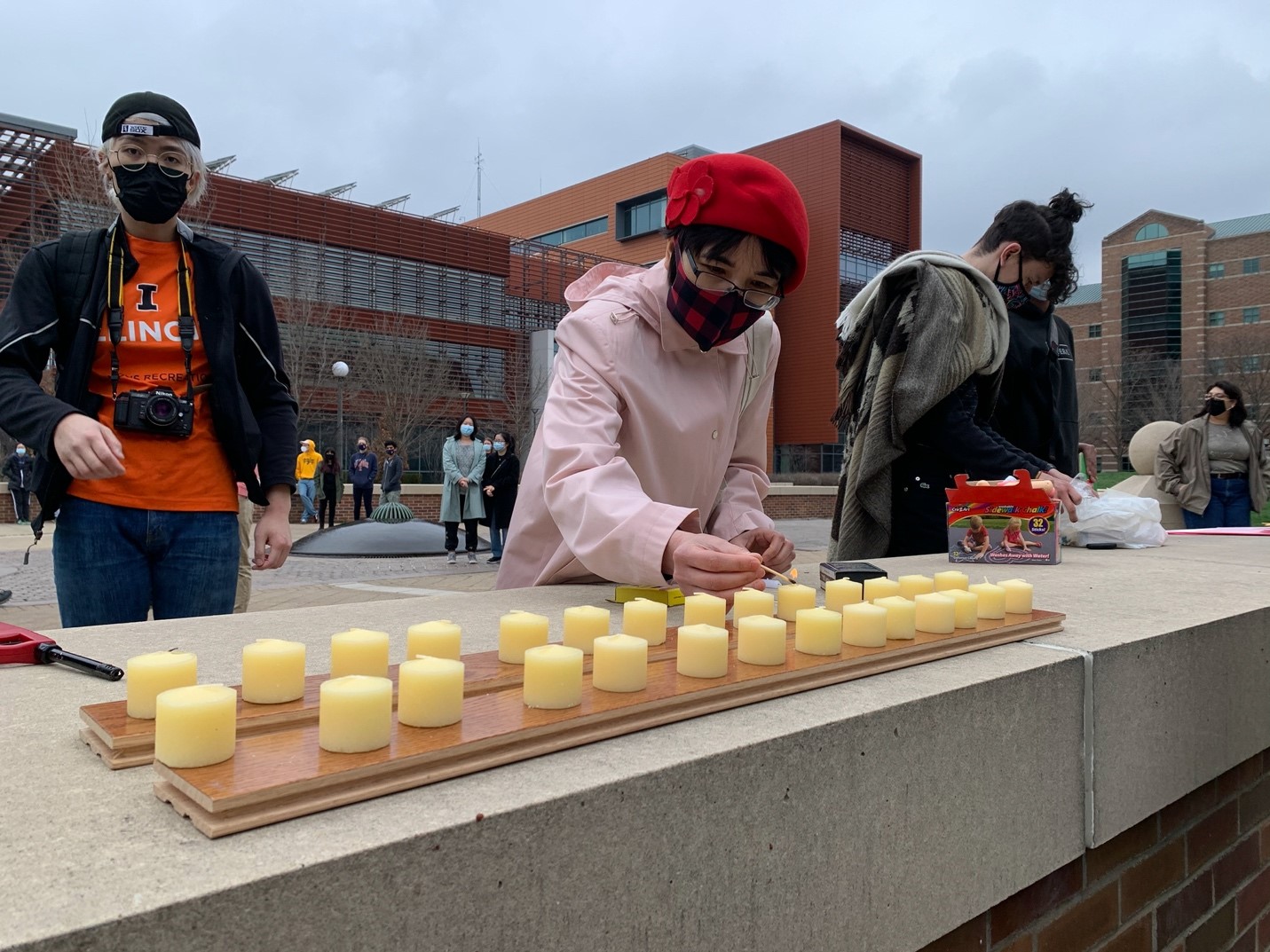 University of Illinois community members light candles during vigil to remember Atlanta spa shooting victims.