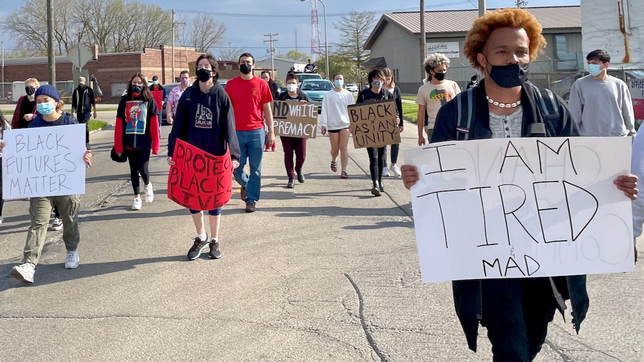 Protestors make their way down Market Street in Champaign. Many participants held signs advocating for people of color and police abolition.