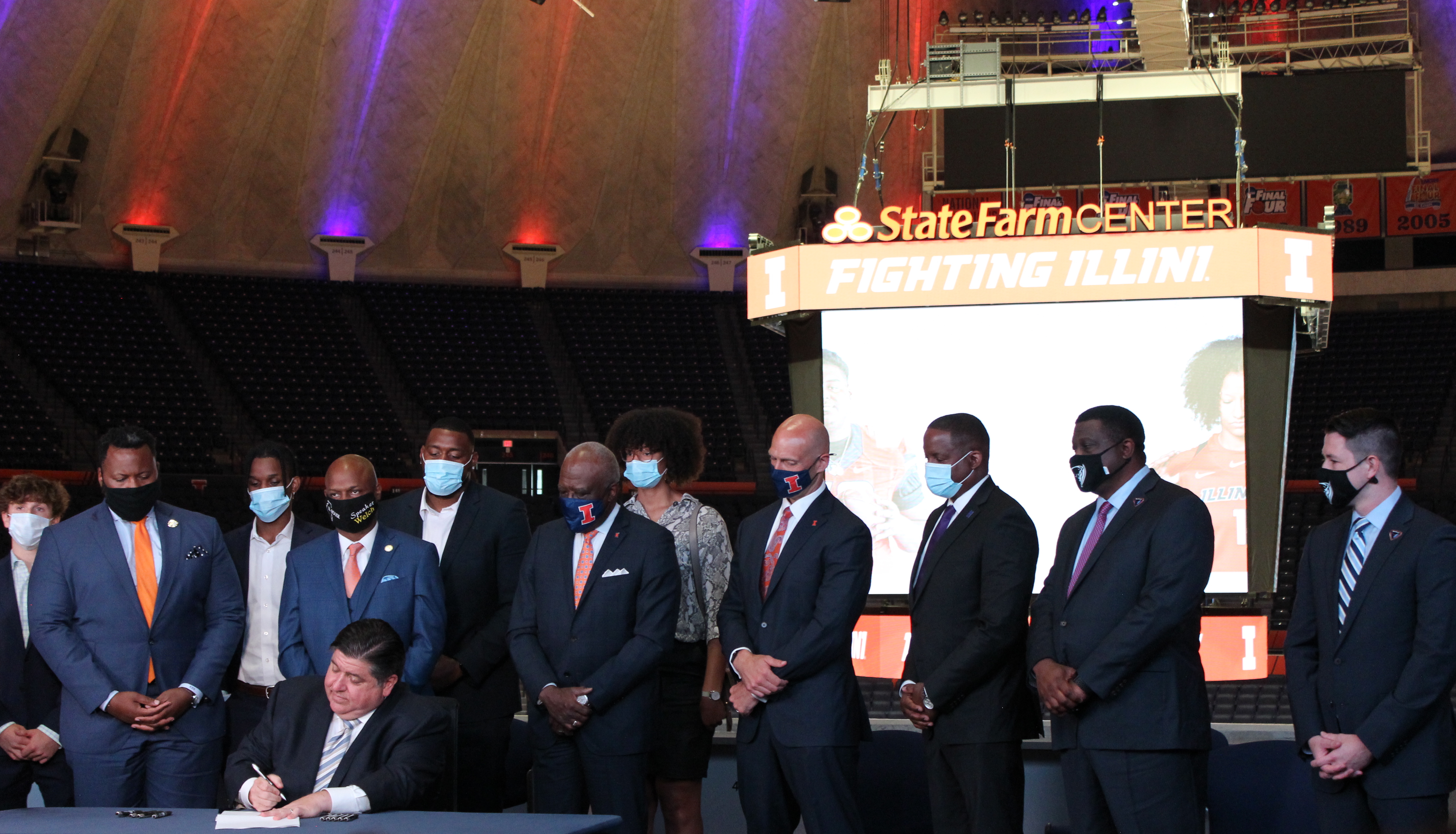 Governor J.B. Pritzker signs the Student-Athlete Endorsement Rights Act at State Farm Center Tuesday. This bill will give Illinois athletes the ability to profit off their name, image and likeness.