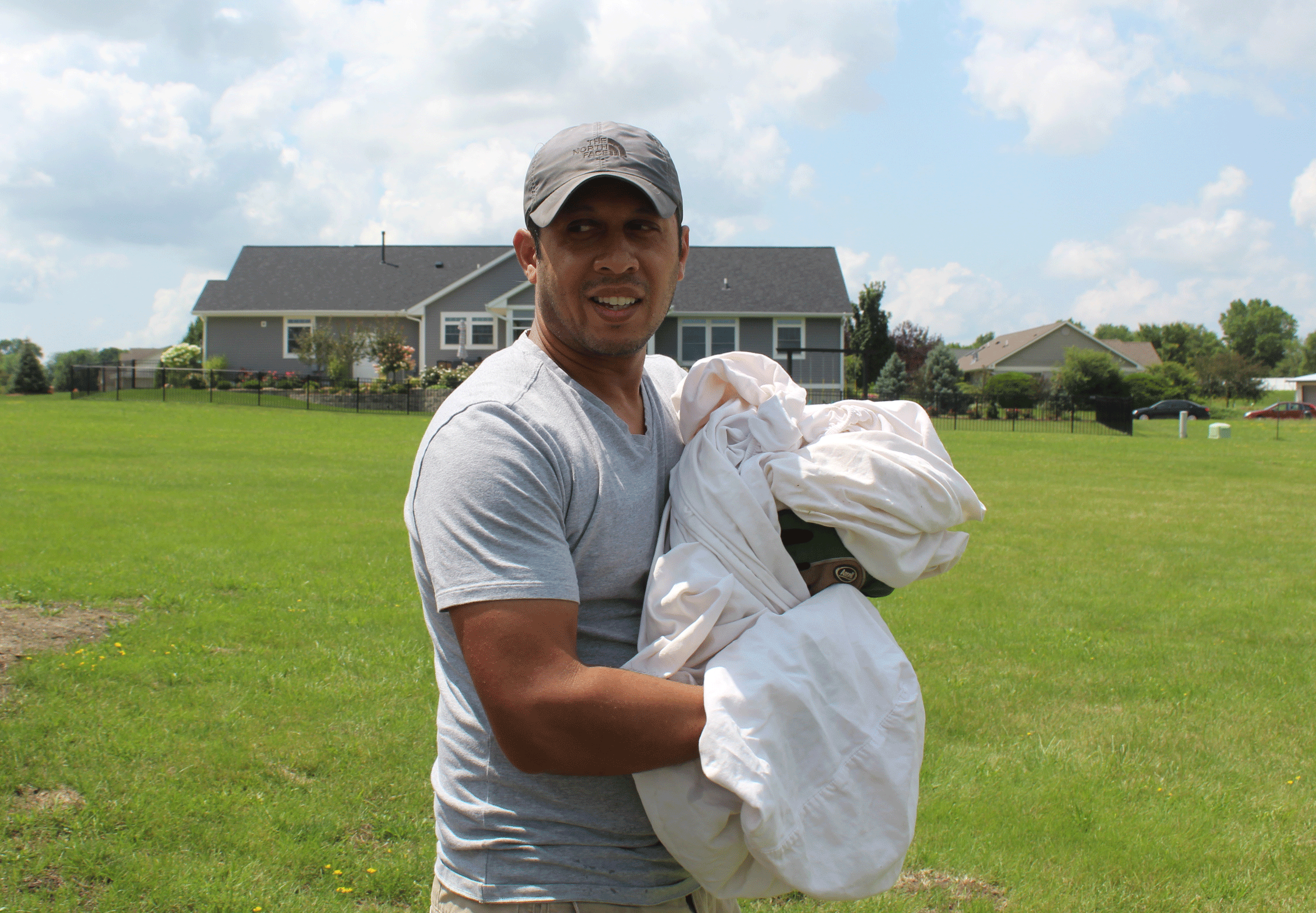 Sean Williams, a Champaign resident, rescues an injured goose at Beringer Commons alongside Friends of Geese Sunday. Over 100 geese were killed at the subdivision at the end of June.