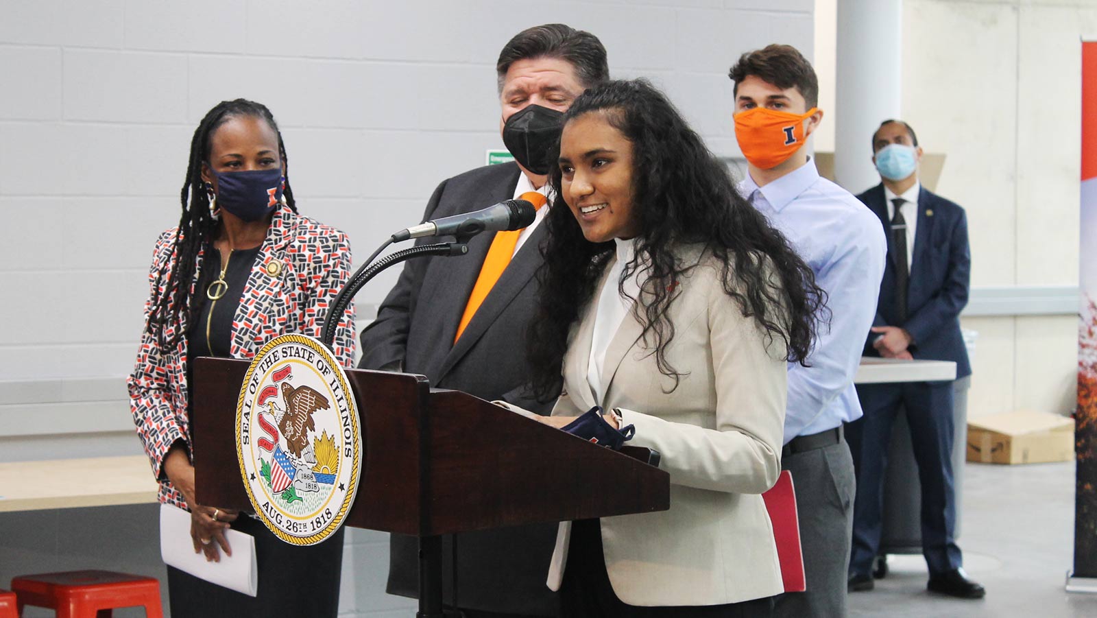 Student Hadiya Jagroop speaks at a podium. 